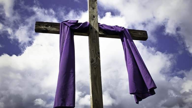 a crucifix wrapped with a purple cloth